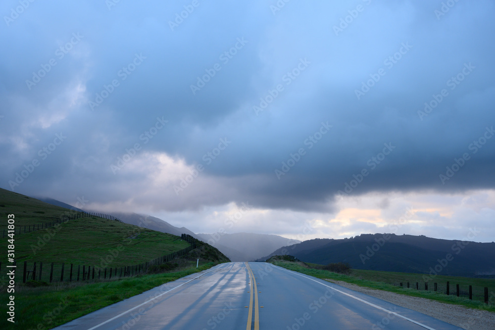 Road Heads into Big Sur Hills Under Rainy Clouds