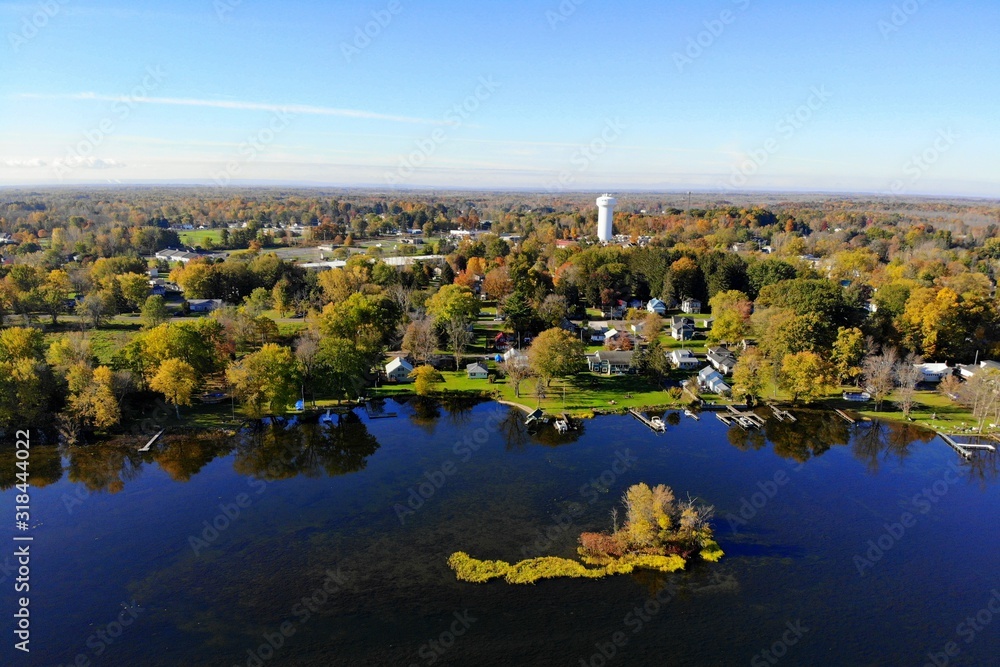The aerial view of the waterfront residential area by Oneida Lake with stunning fall foliage near Syracuse, New York, U.S.A