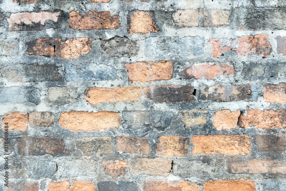 Obraz premium old crack obsolete brick wall with gray stone cement stained background texture nobody.