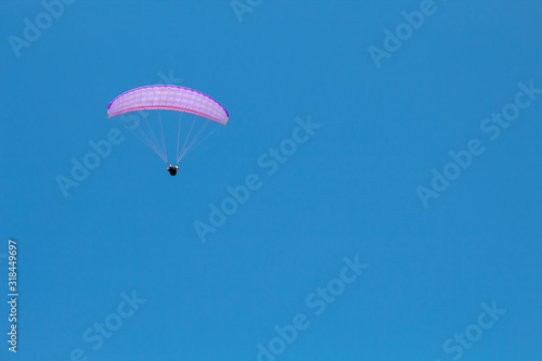 paraglider in flight in the blue sky