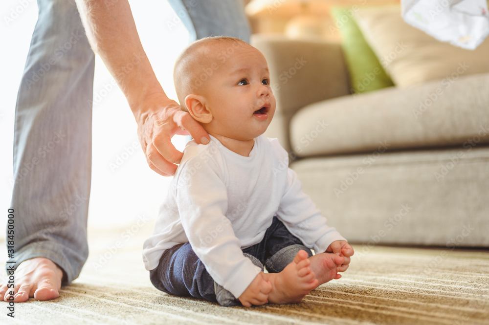 Naklejka premium Father playing with toddler baby son having fun at home in holiday. Family, father, son, baby, Happy, lifestyle concept.