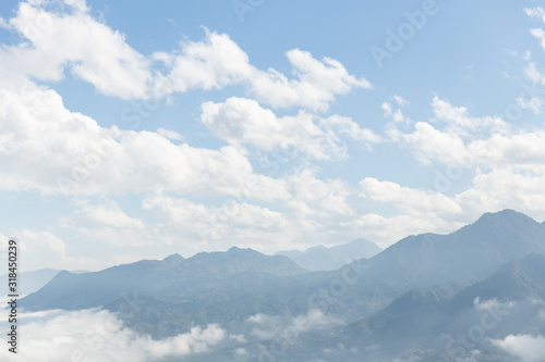landscape view of mountain range under mist with sky cloud
