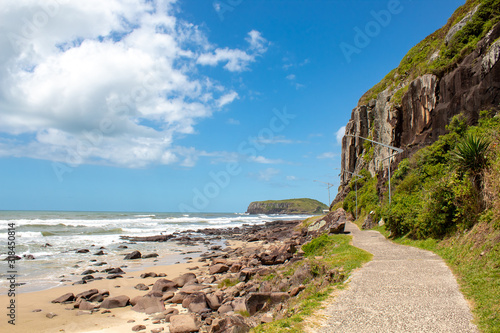 Cliff, sea and sand and blue sky in Torres city, Rio Grande do Sul state, Brazil