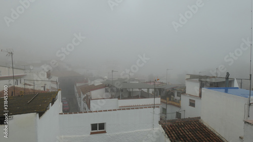 Dense fog covering houses in Andalusian village