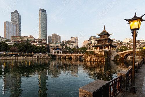 View of the Fuyu bridge and Jiaxiu tower in Guiyang old town which contrast with modern towers in Guizhou province in China