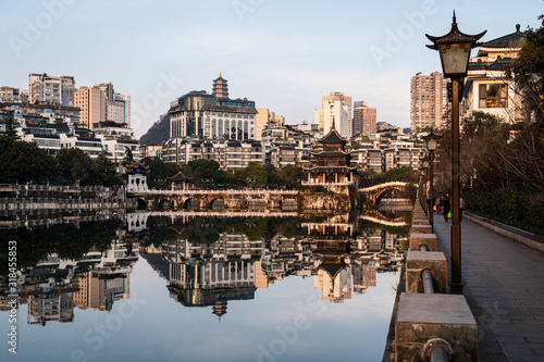 Reflection of the Fuyu bridge and Jiaxiu tower in Guiyang old town in Guizhou province in China photo