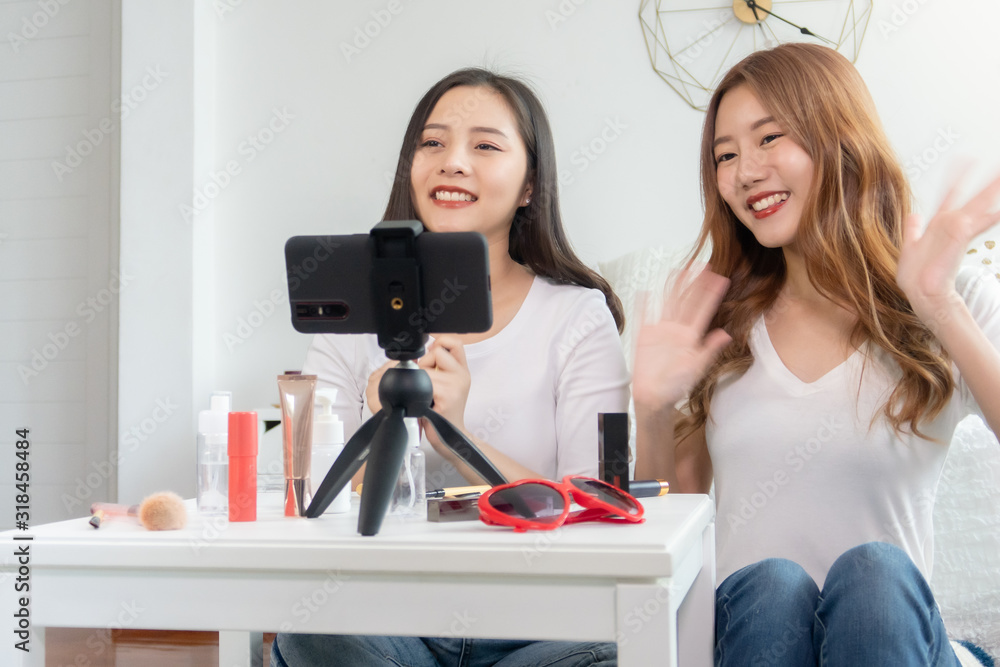 Portrait of young asian woman review giveaway gift product fan following channel, recording video make up lipstic cosmetic at home. Beauty blogger present beauty cosmetics Portrait of young asian woman review giveaway gift product fan following channel, recording video make up lipstic cosmetic at home. Beauty blogger present beauty cosmetics