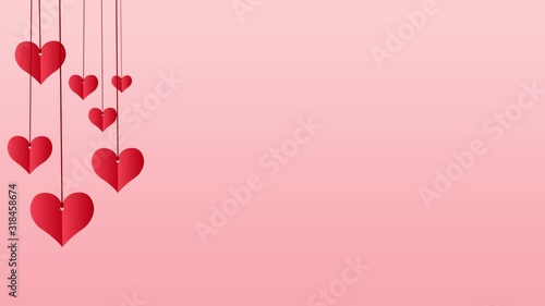Red paper hearts hanging on red string with copy space on pink background
