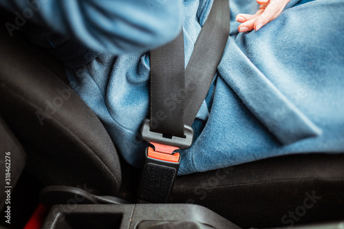 Wallpaper Mural fasten your seat belt. Safety is paramount. the girl fastens the car seat belt. Torontodigital.ca