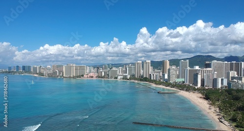 Drone aerial panorama view of Waikiki beach Honolulu Hawaii USA golden beaches turquoise beach lush green palms with hotels resorts in background  © Elias Bitar