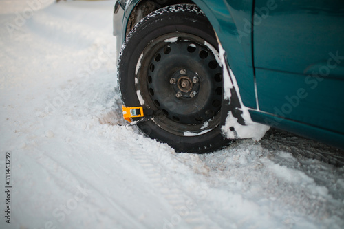 yellow snow chains on a snow car wheel. Wheel close-up. dangerous road, difficult to drive in the snow
