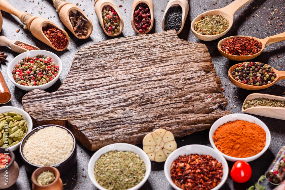 Spices and herbs over black stone background. Top view with free space for menu or recipes Spices and herbs over black stone background. Top view with free space for menu or recipes