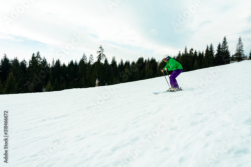 A young man is skiing in the Carpathians on the slopes.