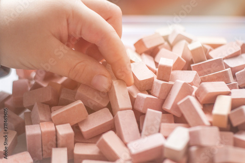 Children's hands play constructor.Little kid collects bricks