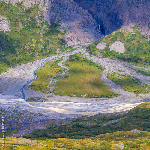 Morning light in a mountain valley. Bends of the river and steppe vegetation on the mountain slopes. photo