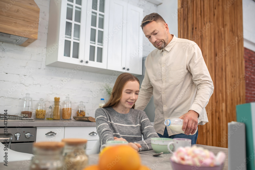 Dad and daughter in the kitchen at breakfast. Dad and daughter in the kitchen at breakfast.