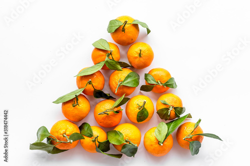 Tangerines with leaves - triangle shape - on white background top-down copy space