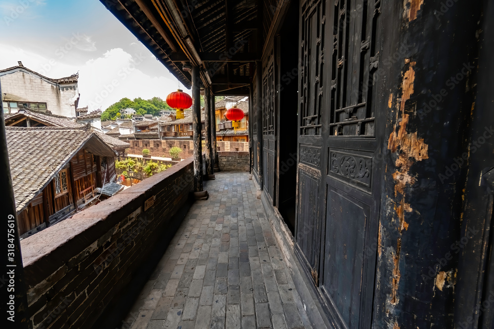 Balcony of an old traditional Chinese house. Walls, balcony, windows, everything is made with wood. Fenghuang Ancient Town, Hunan province, China