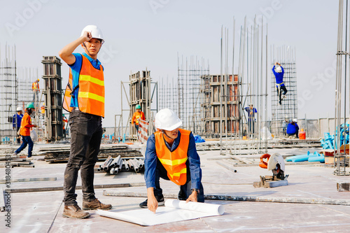 Engineers oversaw the construction site skyscraper.