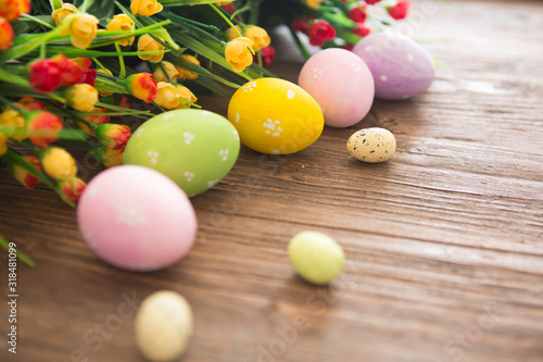 Easter eggs on wooden background. Colorful pastel easter eggs on wooden board background