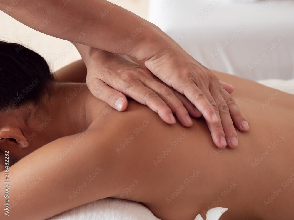 The masseuse's hands moving blur on the backs of Asian woman are a relaxing on bed. Massage and body care. Spa in salon The masseuse's hands moving blur on the backs of Asian woman are a relaxing on bed. Massage and body care. Spa in salon