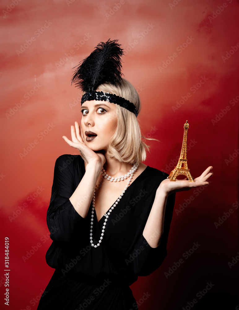 Beautiful blonde woman in twenties years clothes with Eiffel tower statue Beautiful blonde woman in twenties years clothes with Eiffel tower statue