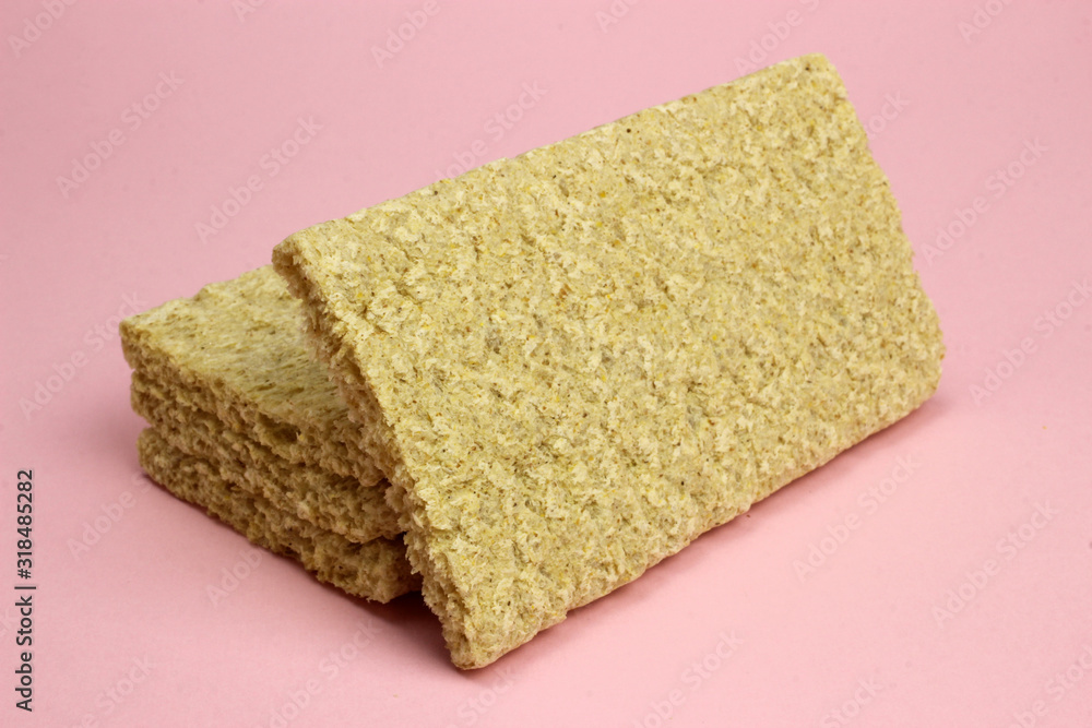 A stack of Crispbread on a pink background. Diet, proper nutrition, Vegan A stack of Crispbread on a pink background. Diet, proper nutrition, Vegan