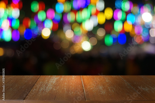 Empty dark wooden table in front of abstract blurred bokeh background of restaurant . can be used for display or montage your products.Mock up for space.