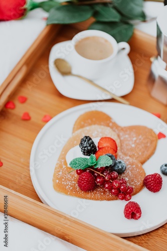 Valentine's Day heart shapes pancake with berries.. morning breakfast with coffee and pancakes