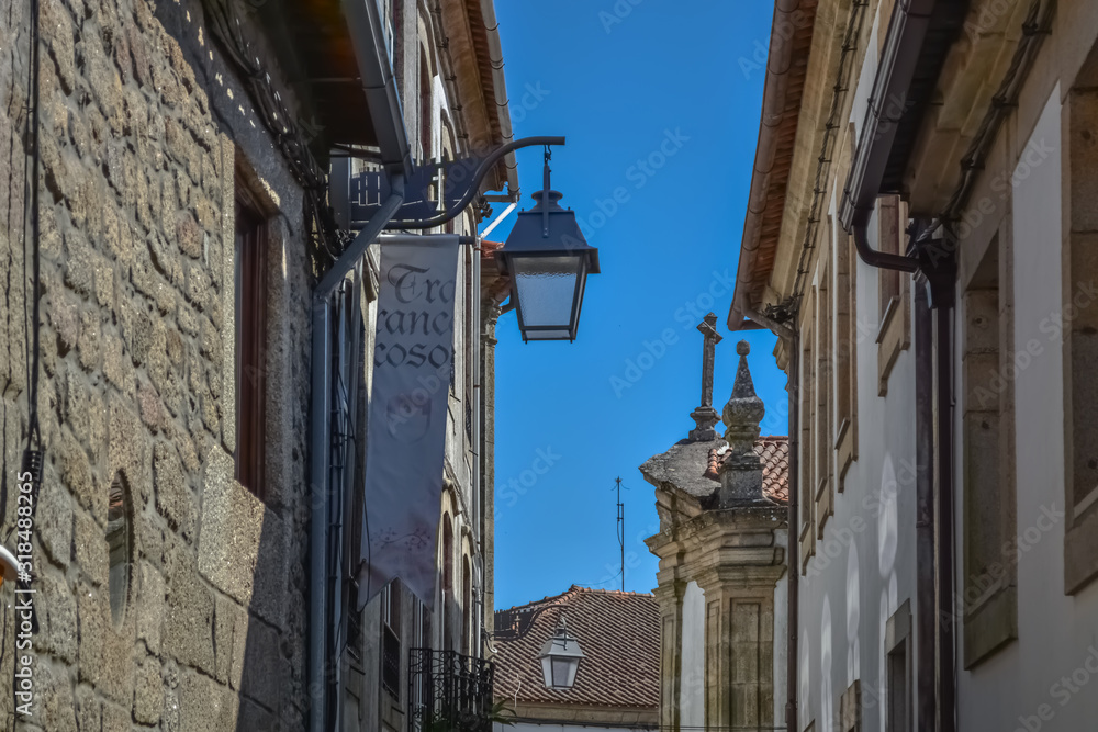 Interior view of the fortified medieval city with walls of Trancoso, with religious old buildings, street lamps