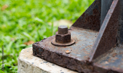 Rusted lighting post steel base plate,  Rusted screw