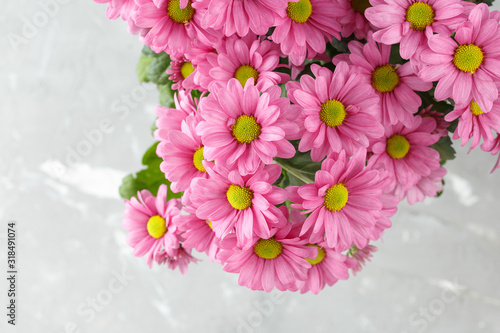 Pink flowers bouquet  over grey background.