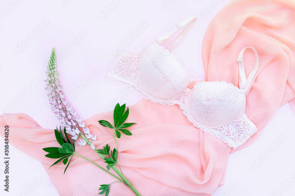 Delicate lace underwear on a pink background with pink lupine flowers. Pastel background. Flat lay, top view. Delicate lace underwear on a pink background with pink lupine flowers. Pastel background. Flat lay, top view.