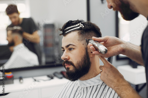 Man with a beard. Hairdresser with a client.