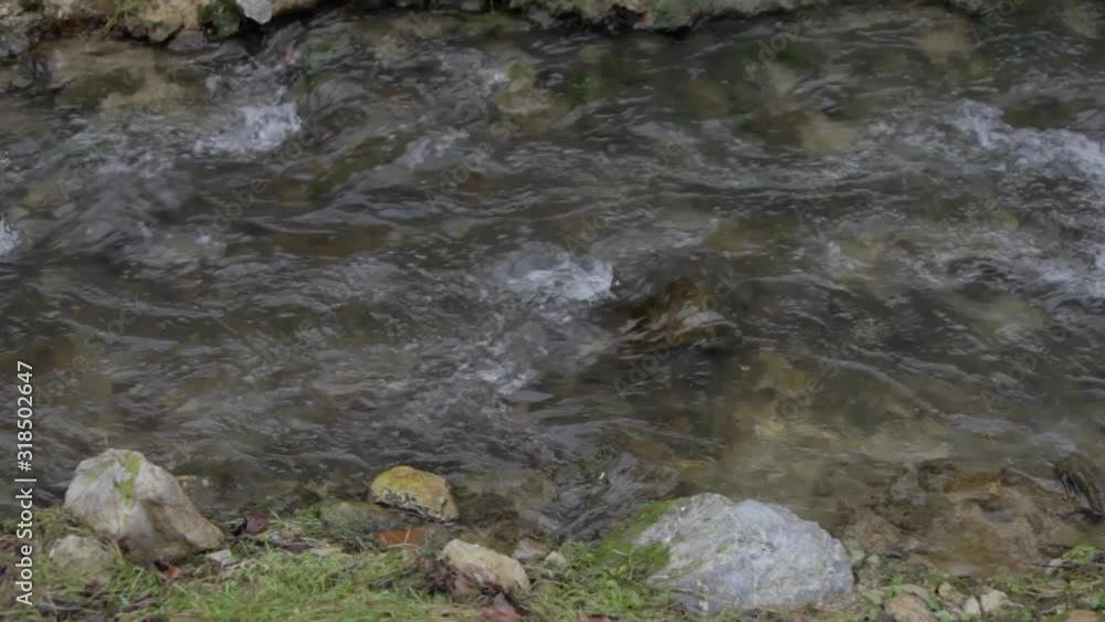 View of a small river waterfall. The river flows through the town View of a small river waterfall. The river flows through the town