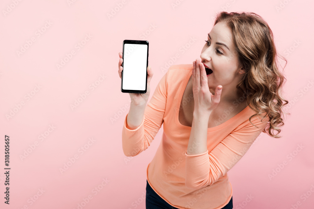 Shocked young woman looking at phone screen. Place for advertising Shocked young woman looking at phone screen. Place for advertising