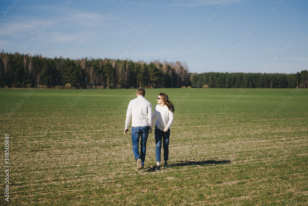 Happy girl and guy running and hugging on the field, love story travel concept, selective focus Happy girl and guy running and hugging on the field, love story travel concept, selective focus
