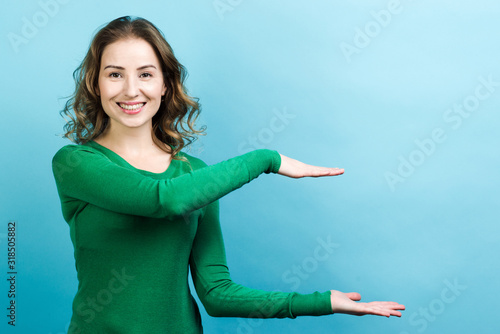 Smiling woman holding virtual object in her hands