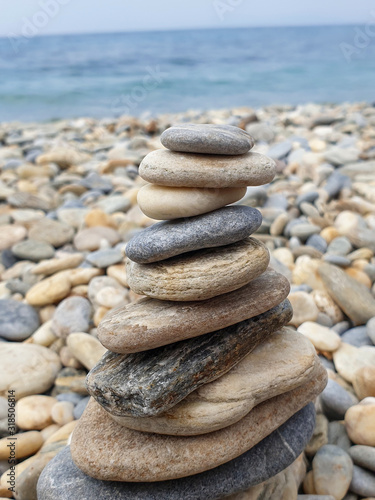 Stones standing in balance against the sea