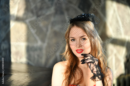 Canvas Print beautiful girl in a black veil and black gloves in a languid pensive pose