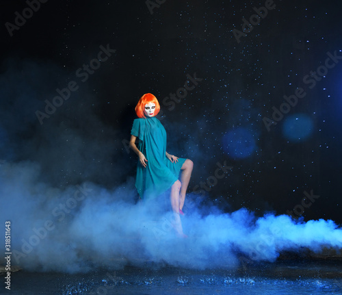 mystical girl with red hair in a white mask on a blue background with smoke