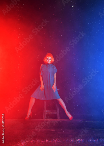 mystical girl with red hair in a white mask on a blue background with smoke