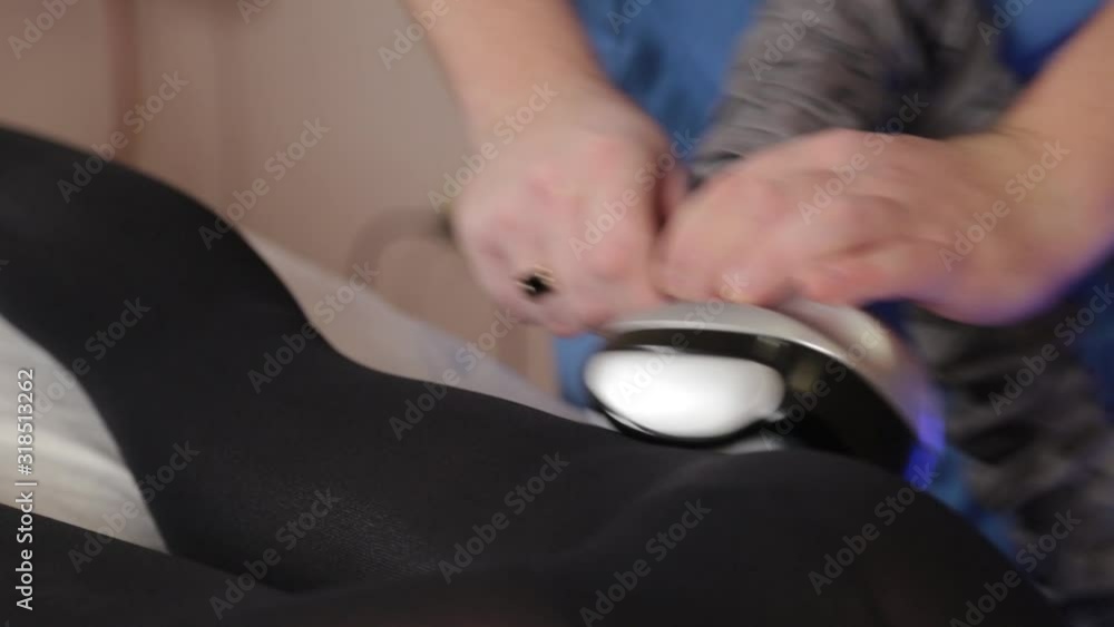Professional male masseur makes a vacuum massage with a special device to a beautiful woman. Professional male masseur makes a vacuum massage with a special device to a beautiful woman.