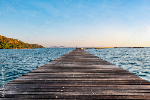 Fototapeta Naklejka Na Ścianę i Meble -  A wooden pier in the morning sunlight