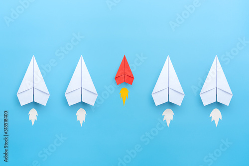 Small business concept with small red paper plane on blue background photo