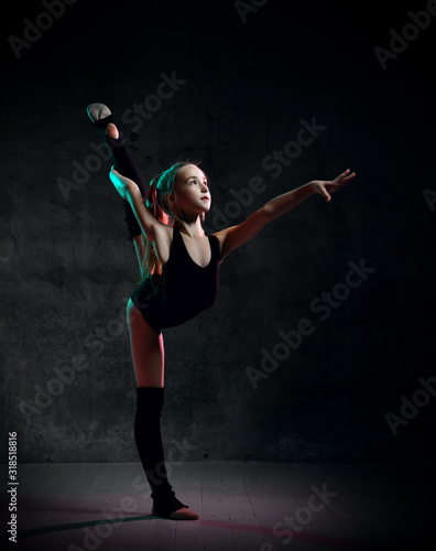 Flexible skinny girl posing in vertical split