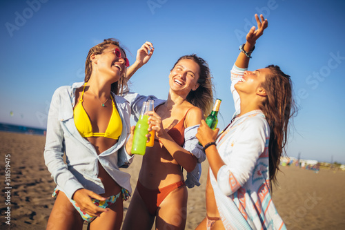 Group of three beautiful attractive young women having fun on the beach. © Mediteraneo