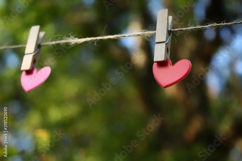 two hearts hanging on a clothesline © Moo Tonk