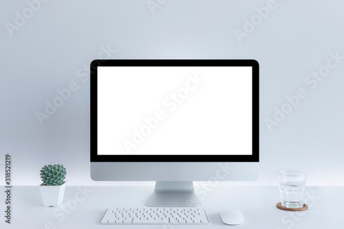 Computer with blank white copy space for text, Mockup design desktop computer in office on white table with keyboard and Coffee cub, Work place concept, Drinking glass, Cactus In pot..