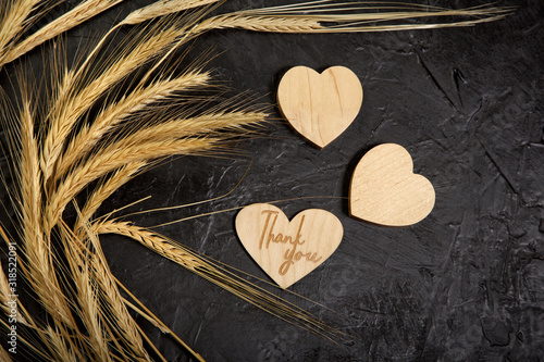 spikelets of wheat on a black background with thanks
